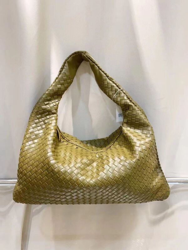 The Bottega Veneta Intrecciato Large Veneta Hobo Bag is a stunning example of luxurious craftsmanship and timeless design. Crafted from soft, supple leather, its signature Intrecciato weave provides both texture and sophistication. This roomy hobo bag features a relaxed, slouchy silhouette that effortlessly combines style with practicality. The spacious interior and single shoulder strap offer both comfort and ease, while the bag’s understated elegance makes it a versatile accessory for both day and evening wear. Perfect for the modern woman who values both form and function. Dimensions: Width: 45 cm Height: 28 cm Depth: 15 cm